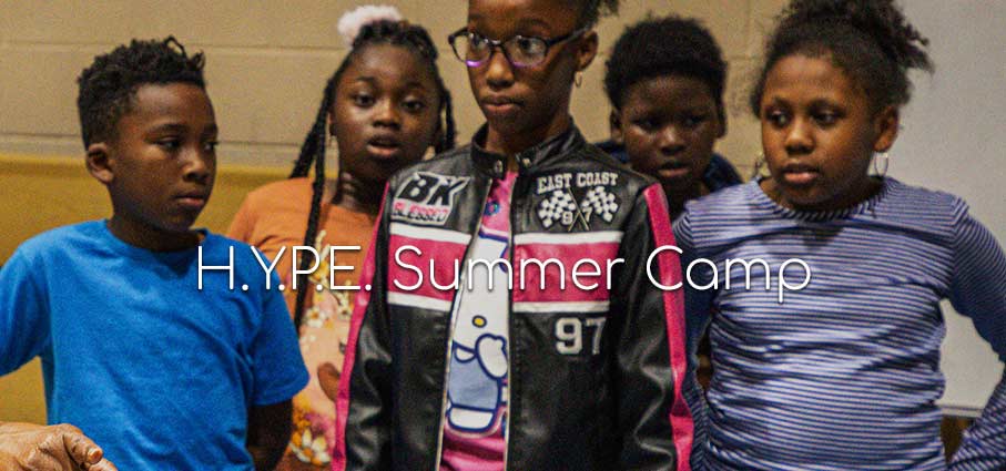 photo of children standing in front of a wall