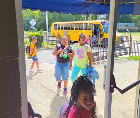 group of kids coming into school